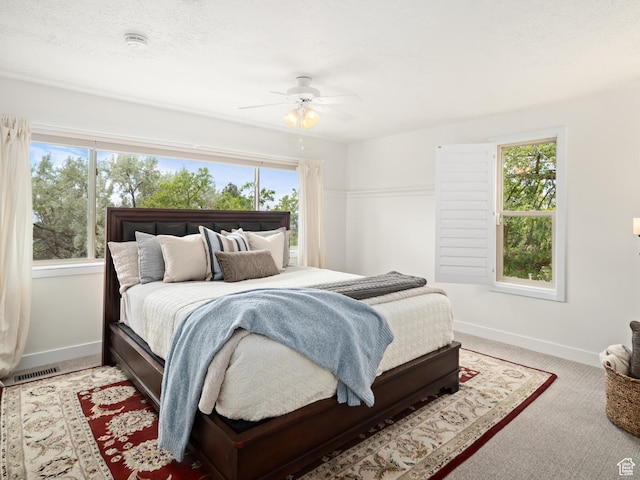 4253 S Spring Rd E, Ogden, UT 84403 - carpeted bedroom featuring multiple windows, baseboards, and a ceiling fan