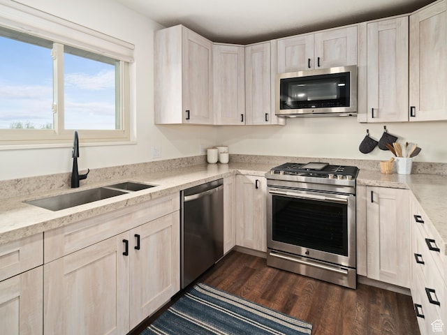 4253 S Spring Rd E, Ogden, UT 84403 - kitchen featuring appliances with stainless steel finishes, a sink, dark wood-style floors, and light stone counters