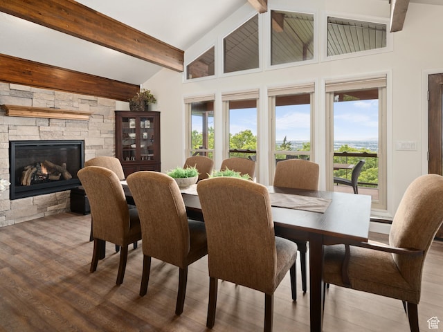4253 S Spring Rd E, Ogden, UT 84403 - dining room with wood finished floors, beamed ceiling, a fireplace, and high vaulted ceiling