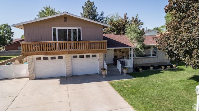 1070 E 120 S, Orem, UT 84097 - view of front of house with concrete driveway, a front yard, an attached garage, stone siding, and covered porch