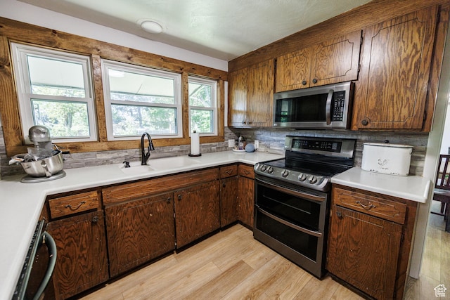 1070 E 120 S, Orem, UT 84097 - kitchen with stainless steel appliances, a sink, light wood finished floors, and light countertops