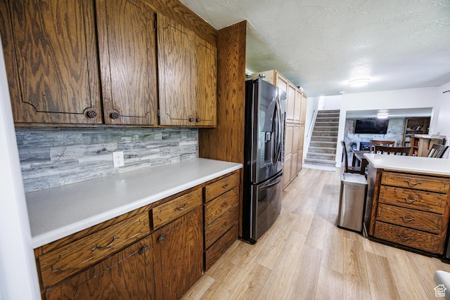 1070 E 120 S, Orem, UT 84097 - kitchen with black fridge with ice dispenser, light wood-style flooring, light countertops, and brown cabinets