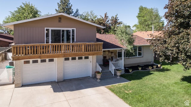 1070 E 120 S, Orem, UT 84097 - view of front of property with driveway, a front yard, an attached garage, a shingled roof, and brick siding