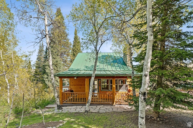 5399 E Targhee Dr E, Oakley, UT 84055 - rear view of house with covered porch, a chimney, faux log siding, and a standing seam roof