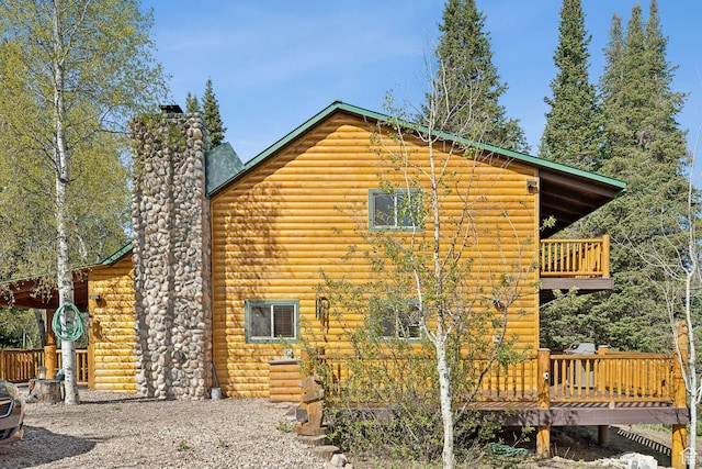 5399 E Targhee Dr E, Oakley, UT 84055 - view of property exterior featuring a chimney, a deck, a balcony, and faux log siding