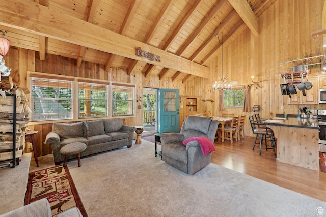5399 E Targhee Dr E, Oakley, UT 84055 - living area with carpet flooring, wooden walls, a chandelier, wood ceiling with exposed beams, and high vaulted ceiling
