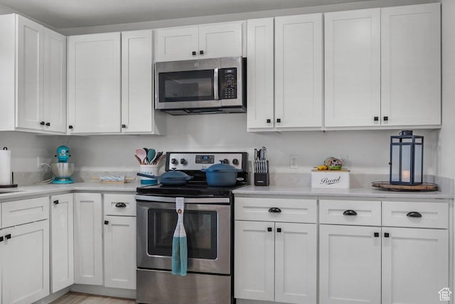 5586 W 10130 N, Highland, UT 84003 - kitchen featuring stainless steel appliances, white cabinetry, and light countertops