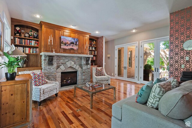 963 E Old English Rd, Draper, UT 84020 - living room with light wood-style flooring, french doors, a stone fireplace, recessed lighting, and baseboards