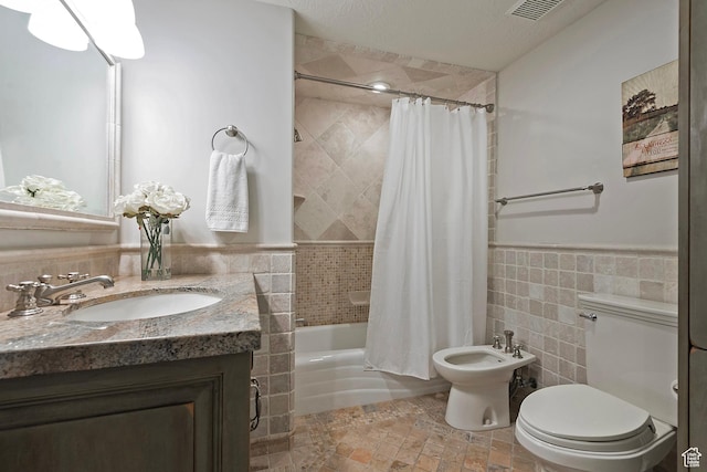 963 E Old English Rd, Draper, UT 84020 - full bath featuring toilet, vanity, shower / tub combo with curtain, tile walls, and a bidet