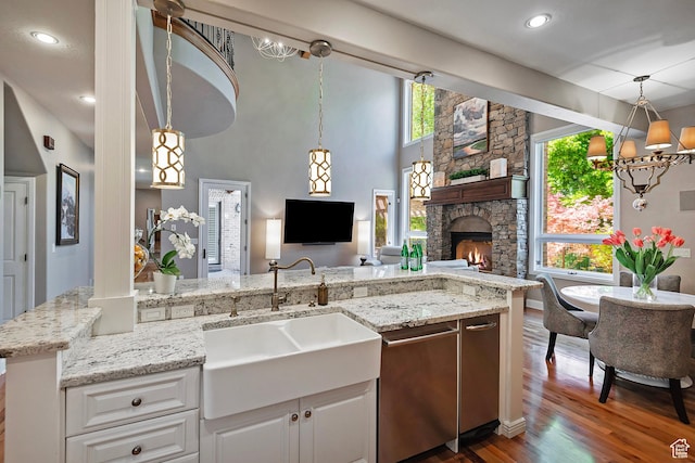 963 E Old English Rd, Draper, UT 84020 - kitchen featuring a sink, dishwasher, dark wood finished floors, open floor plan, and white cabinetry