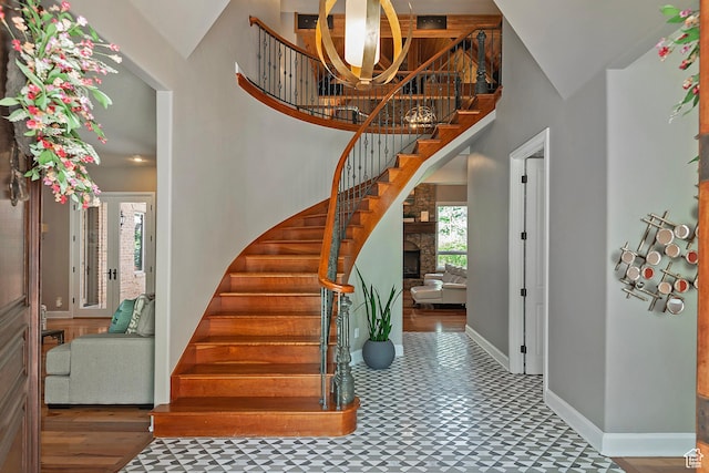 963 E Old English Rd, Draper, UT 84020 - entryway featuring stairs, a towering ceiling, tile patterned floors, baseboards, and a fireplace