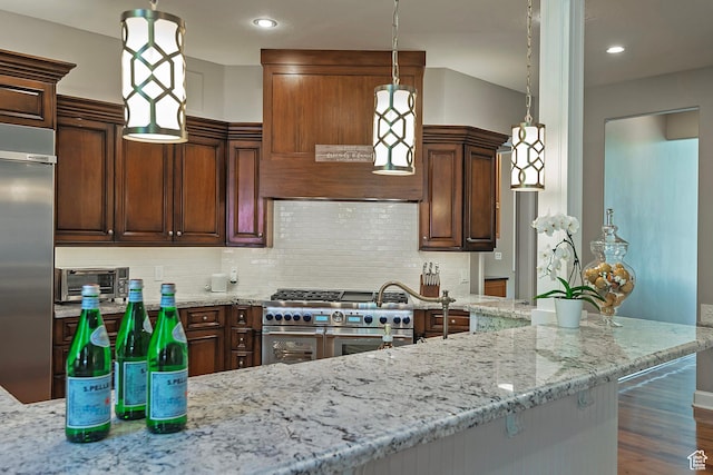 963 E Old English Rd, Draper, UT 84020 - kitchen featuring premium appliances, light stone counters, decorative backsplash, wood finished floors, and recessed lighting