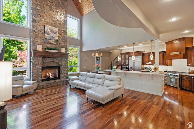 963 E Old English Rd, Draper, UT 84020 - living area with wood-type flooring, a chandelier, a fireplace, high vaulted ceiling, and recessed lighting