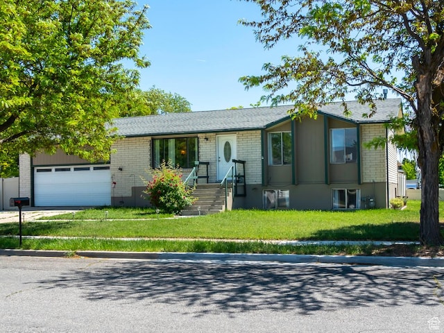 2567 W 2975 S, West Valley City, UT 84119 - ranch-style house with a front lawn, brick siding, and a garage