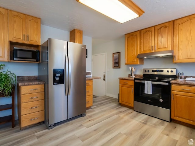 2567 W 2975 S, West Valley City, UT 84119 - kitchen featuring stainless steel appliances, under cabinet range hood, light wood-style flooring, and brown cabinets