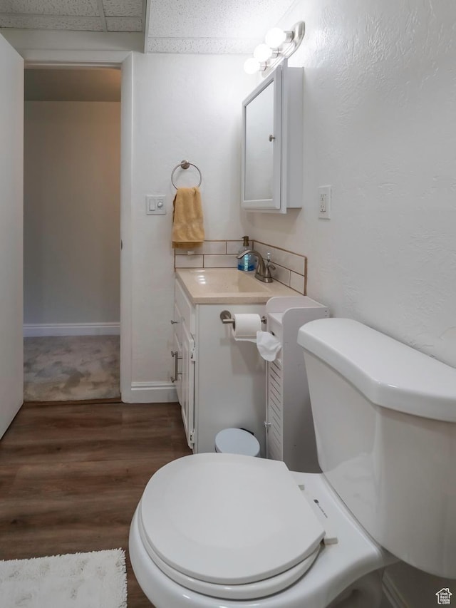 2567 W 2975 S, West Valley City, UT 84119 - bathroom with vanity, wood finished floors, toilet, and baseboards