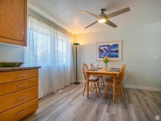 2567 W 2975 S, West Valley City, UT 84119 - dining room featuring light wood-style flooring, baseboards, and ceiling fan
