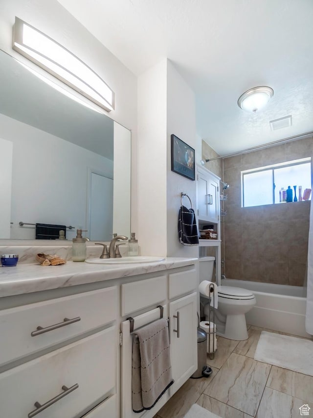 2567 W 2975 S, West Valley City, UT 84119 - bathroom featuring vanity, bathing tub / shower combination, toilet, and marble look tile flooring