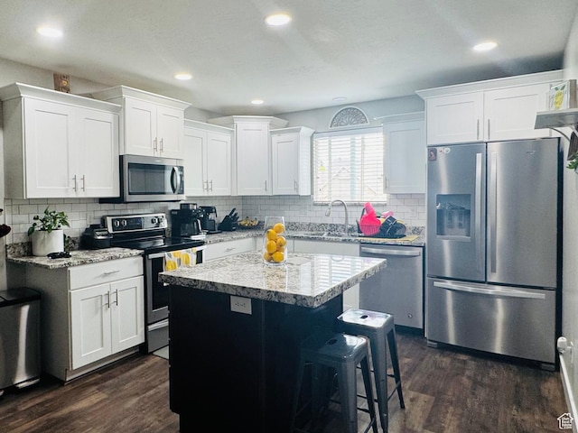 2552 W 2025 N, Clinton, UT 84015 - kitchen with appliances with stainless steel finishes, dark wood finished floors, a sink, white cabinetry, and recessed lighting