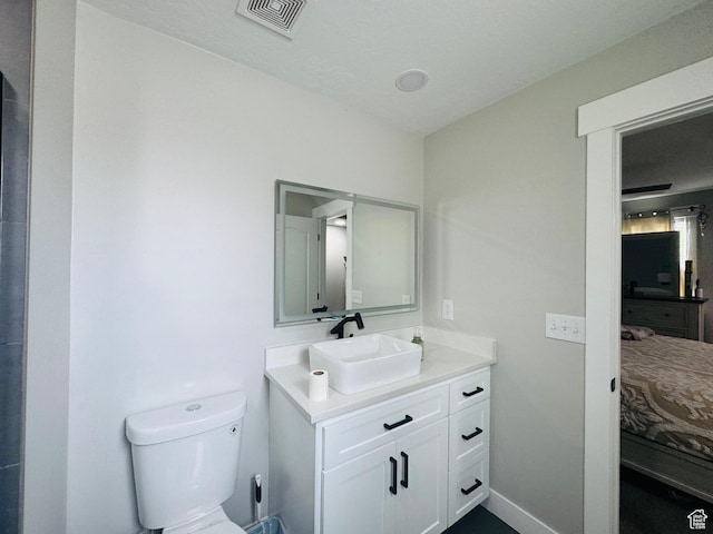 2552 W 2025 N, Clinton, UT 84015 - bathroom featuring vanity, connected bathroom, toilet, and baseboards