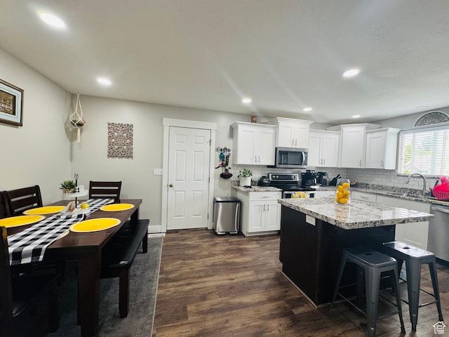 2552 W 2025 N, Clinton, UT 84015 - kitchen with stainless steel appliances, a sink, backsplash, white cabinetry, and recessed lighting