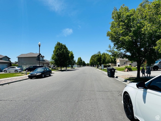 2552 W 2025 N, Clinton, UT 84015 - view of asphalt street featuring sidewalks, street lighting, and curbs