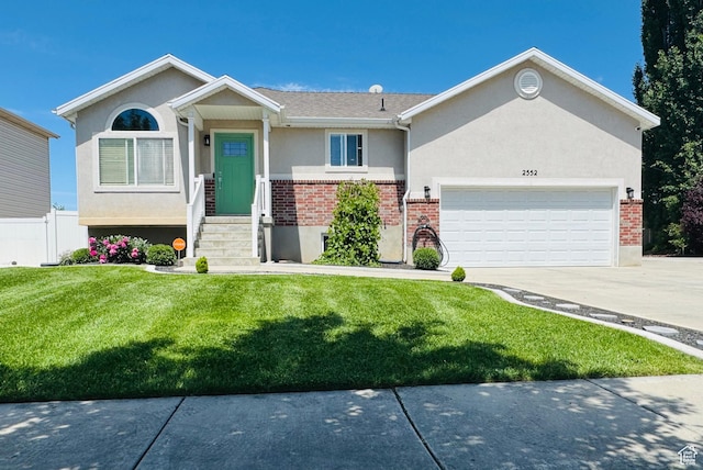 2552 W 2025 N, Clinton, UT 84015 - ranch-style home with brick siding, stucco siding, driveway, and an attached garage