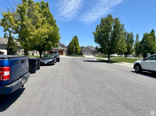 2552 W 2025 N, Clinton, UT 84015 - view of asphalt road featuring a residential view and sidewalks
