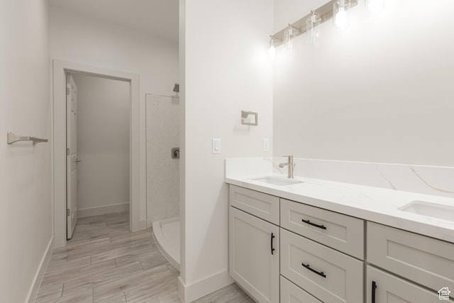2175 W 320 S, Hurricane, UT 84737 - bathroom with a stall shower, double vanity, baseboards, and wood finished floors