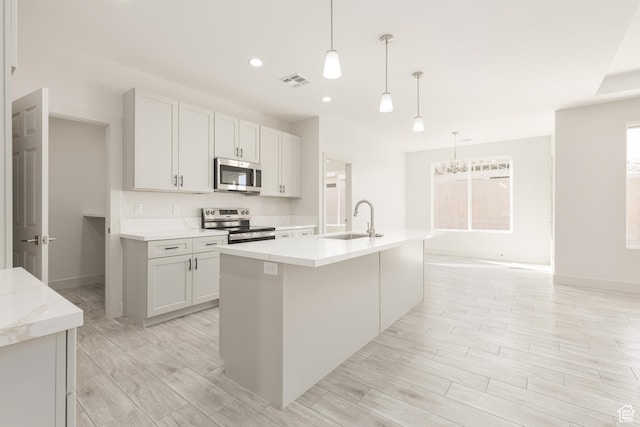 2175 W 320 S, Hurricane, UT 84737 - kitchen with stainless steel appliances, a sink, a kitchen island with sink, baseboards, and recessed lighting