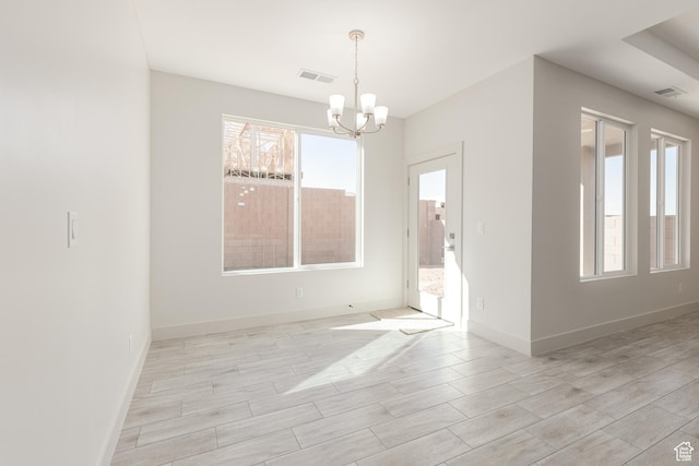 2175 W 320 S, Hurricane, UT 84737 - spare room featuring healthy amount of natural light, a chandelier, light wood-style flooring, and baseboards