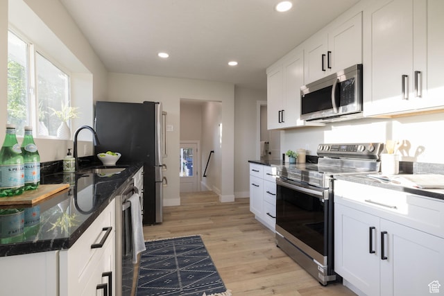 21 E 8680 S, Sandy, UT 84070 - kitchen featuring appliances with stainless steel finishes, a sink, light wood-style flooring, recessed lighting, and white cabinets