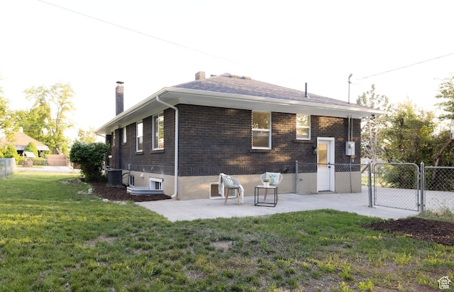 21 E 8680 S, Sandy, UT 84070 - back of house with a gate, a chimney, a patio, brick siding, and central air condition unit