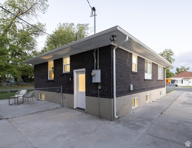 21 E 8680 S, Sandy, UT 84070 - view of side of home featuring brick siding and a patio