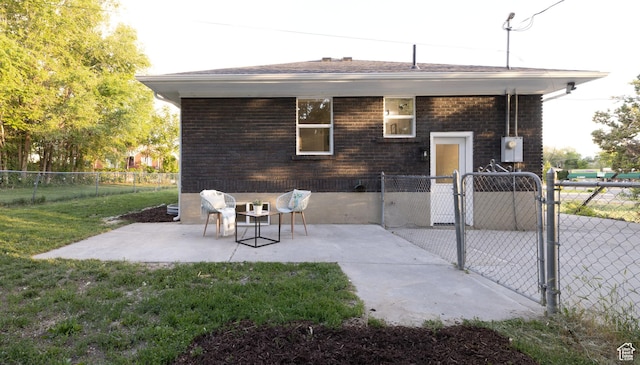21 E 8680 S, Sandy, UT 84070 - back of property featuring a gate, a patio area, and brick siding