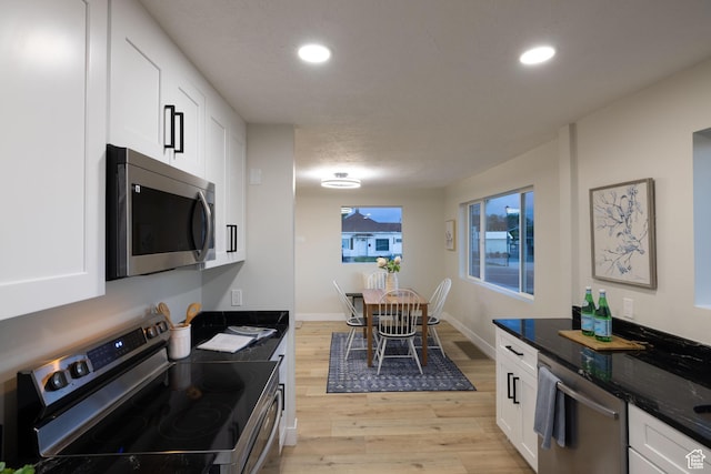 21 E 8680 S, Sandy, UT 84070 - kitchen with appliances with stainless steel finishes, light wood-type flooring, white cabinets, recessed lighting, and dark stone countertops