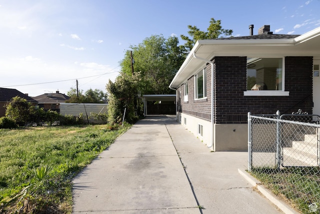 21 E 8680 S, Sandy, UT 84070 - view of side of property with brick siding, a chimney, and concrete driveway