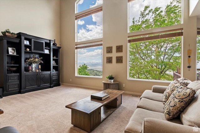 14248 Tumbleweed Way, Draper, UT 84020 - living area featuring light carpet, a high ceiling, and baseboards
