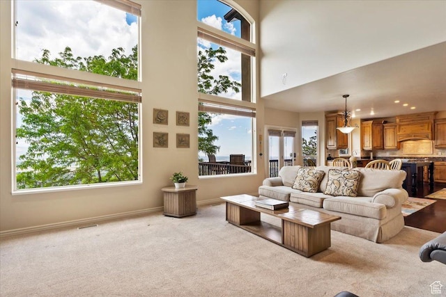 14248 Tumbleweed Way, Draper, UT 84020 - carpeted living room featuring plenty of natural light, a high ceiling, baseboards, and recessed lighting