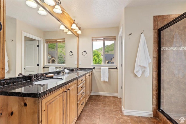 14248 Tumbleweed Way, Draper, UT 84020 - bathroom featuring double vanity, baseboards, and a stall shower