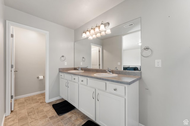 2956 S Willow Creek Dr, Saratoga Springs, UT 84045 - bathroom featuring double vanity, baseboards, and stone finish flooring