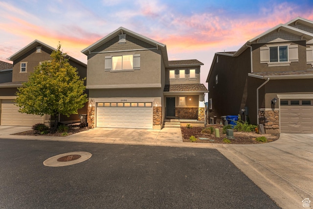 2956 S Willow Creek Dr, Saratoga Springs, UT 84045 - view of front of home with stone siding, driveway, and stucco siding