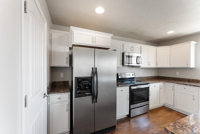 2956 S Willow Creek Dr, Saratoga Springs, UT 84045 - kitchen with stainless steel appliances, white cabinetry, dark wood finished floors, dark stone counters, and recessed lighting