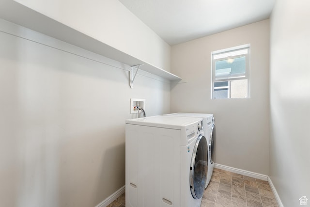 2956 S Willow Creek Dr, Saratoga Springs, UT 84045 - laundry room with washing machine and clothes dryer, baseboards, and stone finish flooring