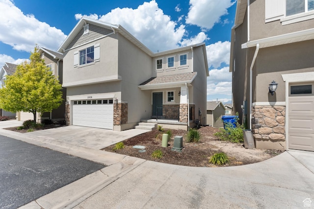 2956 S Willow Creek Dr, Saratoga Springs, UT 84045 - view of front of property featuring stucco siding, stone siding, an attached garage, and concrete driveway
