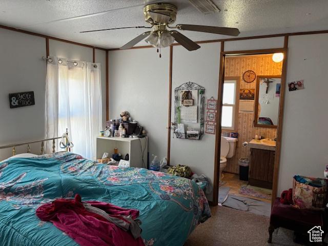 20 N 100 W, Myton, UT 84052 - bedroom featuring carpet, a textured ceiling, ensuite bathroom, and ceiling fan