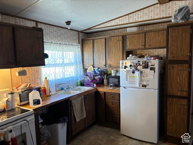 20 N 100 W, Myton, UT 84052 - kitchen featuring freestanding refrigerator, wallpapered walls, black microwave, a sink, and light countertops
