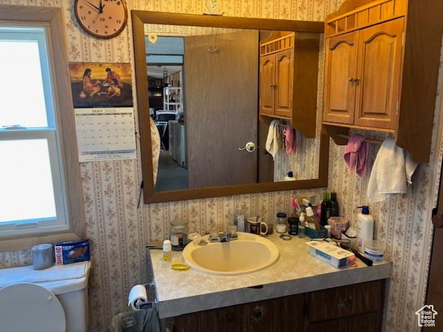 20 N 100 W, Myton, UT 84052 - bathroom featuring wallpapered walls, plenty of natural light, vanity, and toilet