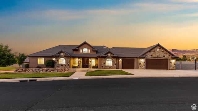 880 N 370 W, La Verkin, UT 84745 - view of front of home featuring stone siding, an attached garage, concrete driveway, and a tile roof
