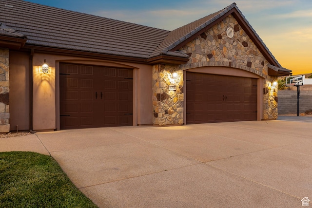 880 N 370 W, La Verkin, UT 84745 - view of front of property with stone siding, a garage, driveway, and a tiled roof
